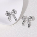 Polished silver bow knot stud earrings in stainless steel on white background - Steel