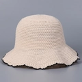 Detail of beige knit bucket hat featuring intricate mesh texture and black wavy edges - M(56-58cm) / Beige