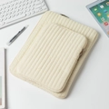 Detailed view of quilted off-white laptop sleeve set with zip and office accessories - 11" / White