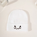 White knitted Halloween beanie featuring a black embroidered pumpkin expression - White