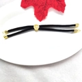 Detail of black Milan cord bracelet with adjustable 18k gold-plated slide clasp and red leaf - Black