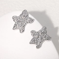Pendientes de estrella en acero inoxidable plateado con textura de lava moderna - Color Acero