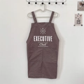 Detail of dark brown chef apron featuring large double pockets and executive print - Dark Grey - EXECUTIVE Chef Print