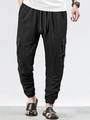 Detail of black waffle texture cargo pants with drawstring waist and cargo pockets - S / Bottoms / Black