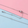 Macro detail of silver stainless steel cable chain with lobster clasp and extension - Steel