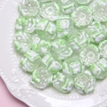 DIY glass beads with white and light green patterns in a ceramic dish for jewelry making - Clear Bead + Green Heart + Cup