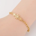 Close-up of a gold snowflake bracelet for women on a wrist made of stainless steel - Snowflake / Gold