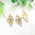 Gold Hamsa Hand charms with blue Evil Eye and clear crystals on marble background - KC Gold Evil Eye Hamsa-14581
