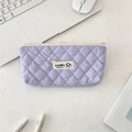 Top view of a lavender quilted pencil case on a desk with laptop and office accessories - Light Purple