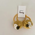 Detail of yellow knitted strawberry hair ties for kids with white flowers and green leaves - Yellow Pumpkin