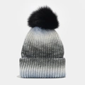 Detail of gradient rib-knit winter hat featuring a fluffy black faux fur pom-pom - Black & Blue