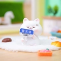 White cartoon cat figurine holding a blue sign on soft white plush carpet background - Speechless White Cat (1188-35)