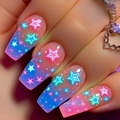 Detail of coffin nails with pink and blue gradient and neon glowing star patterns - Neon Star Pink Blue Gradient Style (AW379)