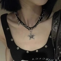 Macro view of punk star pendant with silver spikes on a black leather necklace - Skull Star Choker