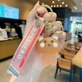 Süßer brauner Bär Schlüsselanhänger mit rosa Superhero Armband und Goldring - Kristall Blush Bär