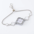 Detailed close-up of a silver four-leaf clover bracelet watch with a crystal square bezel - Silver-Clover White Dial
