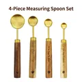 4-piece golden stainless steel measuring spoon set with acacia wood handles on white background - Gold Measuring Spoon Set of 4
