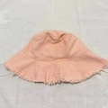 Unisex pink frayed brim cotton bucket hat displayed on a white textured background - M (56-58cm) / Light Pink