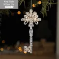 Sparkling gold sequined key-shaped Christmas tree ornament with silver hanging string - Key Style