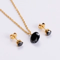 Detail of elegant gold jewelry set featuring faceted black oval and round gemstones - Gold Chain + Black Zirconia