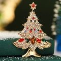 Golden Christmas tree brooch with colorful crystals on a festive snowy background - Full Rhinestone Christmas Tree
