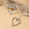 Silver irregular heart-shaped hook earrings on a minimalist wooden display stand - Trend Large Heart Earrings