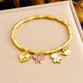 Bracciale in acciaio dorato stile bambù con ciondoli a cuore, farfalla e corona - Serie Carina Farfalla Corona Cuore (B1628)