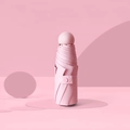Pink mini capsule umbrella with round handle and snap strap in storage state - With Capsule Box / 6 Ribs Thickened Black Glue / Light Pink