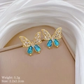 Macro view of blue butterfly earrings with gold frame and cubic zirconia stones - Butterfly Stud Earrings (D538)