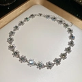 Detailed close-up of sparkling flower pendant necklace with central gem and lobster clasp - Necklace-Silver-Grey