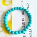 Handmade 8mm turquoise stone bead bracelet with unique blue tones and natural yellow veining - Gold Line Blue Turquoise