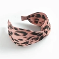 Pink satin headband with black leopard print and bunny ear knot design on white background - Brown Red Leopard Print