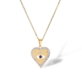 Gold evil eye heart necklace with blue gemstone and sparkling crystals on white background - Gold