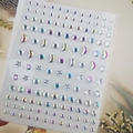 Macro view of iridescent moon and star face gems on a transparent backing sheet - BJA-702 (AB Color Star Moon)