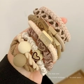 Elastic hair ties set in beige and coffee tones featuring woven bands and heart charms - Cream
