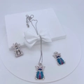 Detail of silver insect jewelry set featuring zircon inlay on white display stand - Necklace and Earring Set / Silver Blue Pink Rhinestone Beetle Set