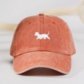Close-up of white puppy embroidery on vintage washed cotton brick red baseball cap - One Size / Orange