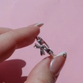 Close-up of a silver bow-shaped open ring with 18K plating on a finger - Steel Butterfly Bow