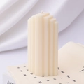 Creamy white geometric step aromatherapy candle with minimalist vertical striped design - Tapered Leg