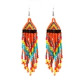 Detail shot of bohemian handmade seed bead tassel earrings with vibrant multicolor fringe - Orange Multicolor