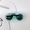 Flat lay of mint green shield sunglasses with golden side accents and dark lenses - Green Frame