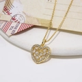 Elegant gold heart pendant necklace with shimmering zircon stones on a ceramic tray - Heart Pendant Necklace (ZYN-DMK519G)