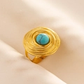 Detailed view of a gold boho ring with a turquoise stone on beige textured fabric - Gold Base-Light Blue Stone