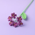 Macro shot of handcrafted purple crochet forget-me-not flower with fine yarn texture - Forget-me-not / Deep purple
