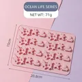 Pink silicone gummy mold with 32 cavities featuring sea creatures like sharks and dolphins - Ocean Animals