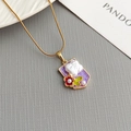 Elegant gold necklace with purple enamel pendant, baroque pearl, and flower charm details - Purple