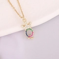 Detailed close-up of a 18K gold-plated crown pendant with colorful zircon micro-inlay - Letter Q Style