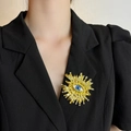 Detailed view of Evil Eye brooch with blue eye and gold finish on a black blazer - Sun Evil Eye Gold Brooch