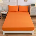 Solid orange fitted sheet set with matching pillowcases in a modern bedroom interior - Orange