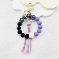 Black and lilac silicone bead keychain with paw prints, wooden bead, and tassel - Purple Paw Print